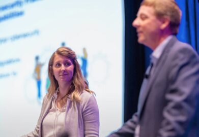 tom conkle and kelly hood on stage speaking at infosec world conference